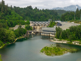 Hydroelectric Dam and Reservoir at Mission BC Canada Surrounded by Forested Mountains and River © edb3_16