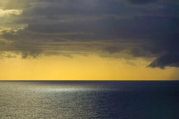 Obraz premium Dramatic storm clouds over the Mediterranean Sea at sunset