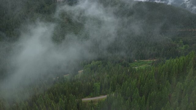 Aerial through low clouds in St Joe national forest in Wallace Idaho in spring