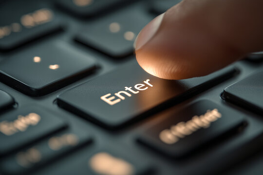 Close up of human finger pressing glowing enter key button on black computer laptop keyboard conceptual image for starting next step submitting data confirmation