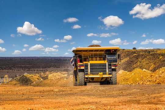 Mining haul truck transporting soil load in open pit mine industrial quarry