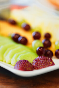 Fresh sliced fruit platter on breakfast buffet table at a hotel brunch