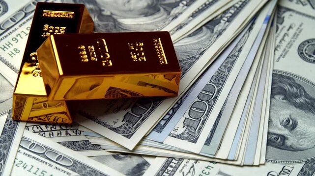 Luxurious gold bars sit atop neatly arranged hundred-dollar bills, showcasing a stunning relationship between wealth and power