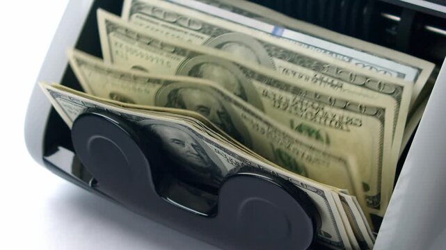 Watch as crisp bills swiftly flow through a modern money counting machine, transforming a pile of cash into neat stacks while ensuring accuracy and efficiency