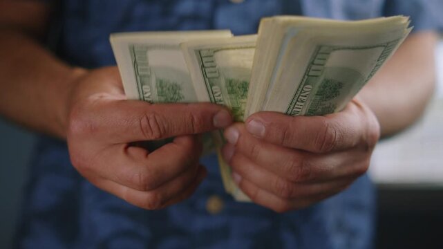 Hands carefully sort through crisp bills, each note revealing excitement and anticipation in a bright, warm setting filled with light