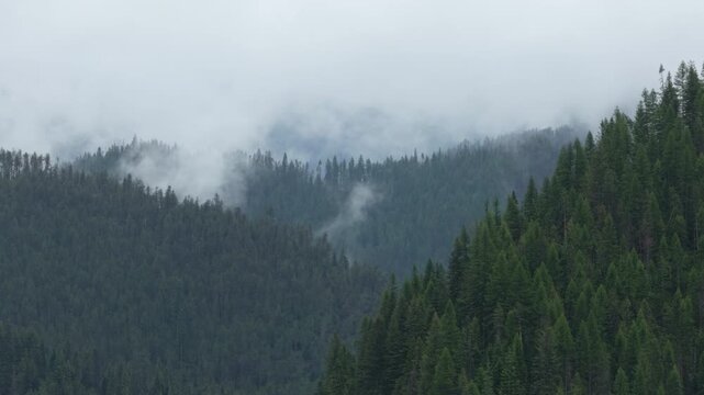 Aerial zoom shot of low clouds St Joe Mountains near Wallace Idaho in spring
