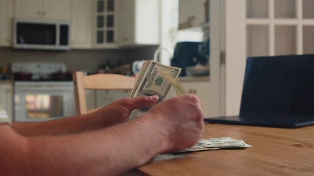 Gathered around the wooden kitchen table, hands skillfully count and organize crisp bills. The warm afternoon glow enhances this simple yet rewarding moment