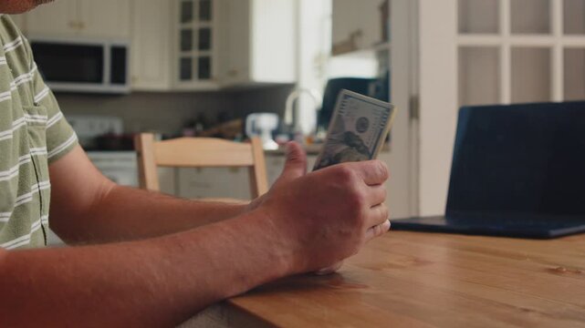 Fingers gently sift through crisp dollar bills at a simple wooden table in a sunlit kitchen, reflecting the joy of newfound wealth and opportunity