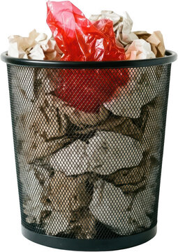 A black metal mesh trash can filled with crumpled brown paper and a single bright red plastic bag overflowing at the top waste bin garbage can office bin bin waste rubbish