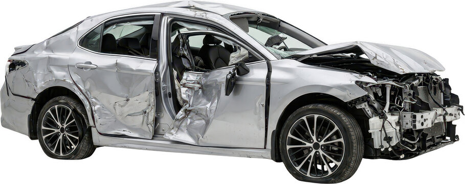 A crumpled silver sedan shows severe damage to the front side doors and fender with its hood bent upwards and a missing bumper car crash automobile accident