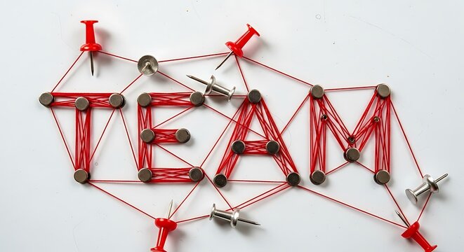 Red string and push pin TEAM concept on white background with silver and red pins