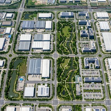 Top-down aerial drone view of an industrial and commercial district featuring factory buildings