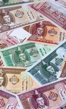 Mongolian tugrik money bills in pile. Big amount of Mongolia MNT currency cash close up