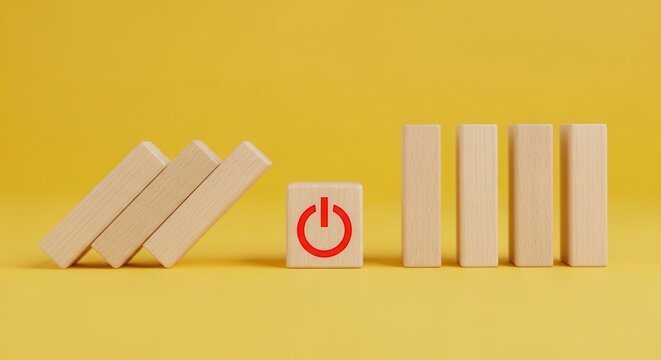 Wooden blocks with power button symbol on yellow background - business startup concept