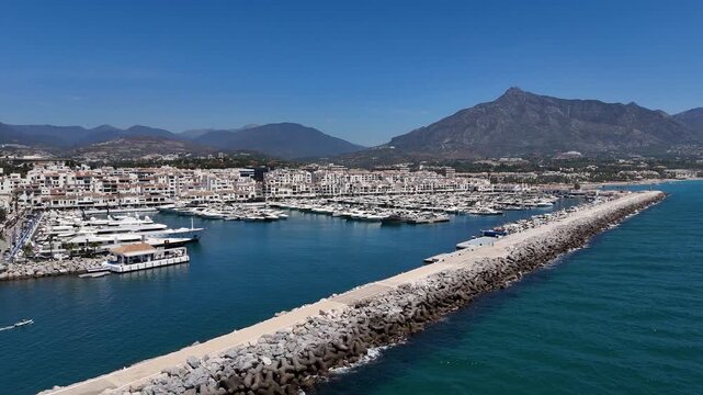 Puerto Banus breakwater tetrapod marina boats Marbella aerial 4K coast
