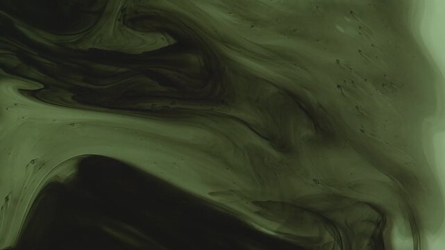 Abstract background of dark green and black ink swirling underwater. Mesmerizing fluid motion creates a moody, smoky organic pattern. Perfect for dramatic overlays.