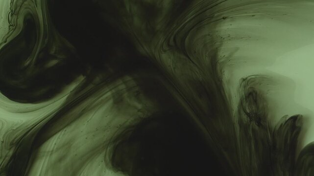 Abstract background of dark green and black ink swirling underwater. Mesmerizing fluid motion creates a moody, smoky organic pattern. Perfect for dramatic overlays.