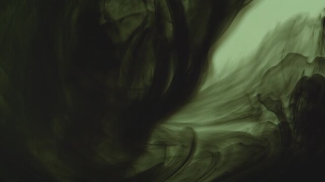Abstract background of dark green and black ink swirling underwater. Mesmerizing fluid motion creates a moody, smoky organic pattern. Perfect for dramatic overlays.