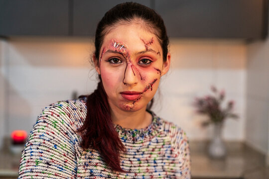 Direct flash portrait of a costumed character with gory wounds looking aside