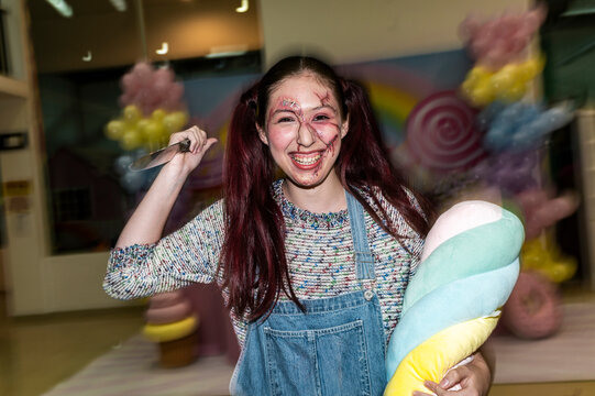 Sinister character wielding a knife with loose hair in a candy colored set