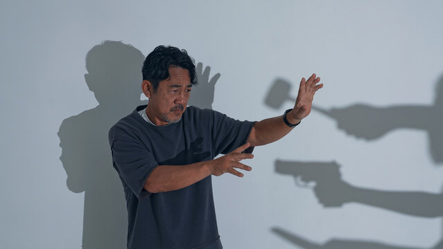 武器を持った集団に立ち向かうミドル男性