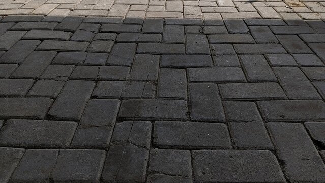 Dark and Light Interlocking Pavers Creating a Contrasting Pattern.