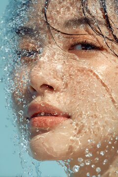 Close-up of a female beauty model's face with an ice-cooling skincare concept, hydrating cosmetics advertisement