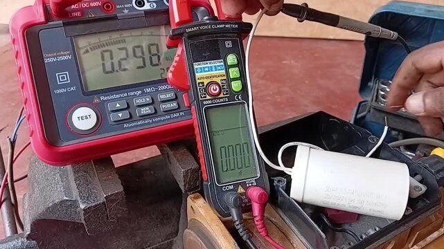 Electrician Testing The Microfarad Value Of A Motor Run Capacitor Using A Digital Clamp Meter