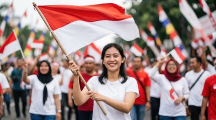 Fototapeta premium A proud woman leads a parade, holding a national flag high. A crowd of people in the background also carries flags, showcasing national unity and pride