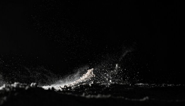 Fine powder cloud exploding against darkness