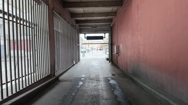 Empty Underground Parking Garage Ramp with Pink Concrete Walls in Bordeaux