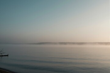 Obraz premium A weathered wooden boat rests on the serene lakeshore of Mecklenburg-Vorpommern, Germany, shrouded in morning fog.