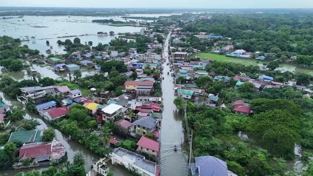 Extreme weather and natural disaster drone footage of flooded provincial town in the Philippines during a heavy monsoon rainstorm - Flooded highway 