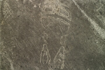 Fototapeta premium Abstract Ancient Rock Carving of a Symbolic Figure Found on Weathered Stone Surface Showcasing Prehistoric Artistic Expression and Archaeological Heritage