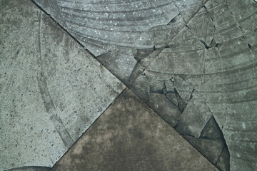 Obraz premium Abstract macro detail of weathered grey stone pavement with geometric cracks and textured mineral surfaces creating a rustic architectural pattern