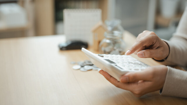 Person calculating expenses and managing bill payment reminders with budgeting tools. Concept of personal finance, recurring payments, financial planning, and expense control.