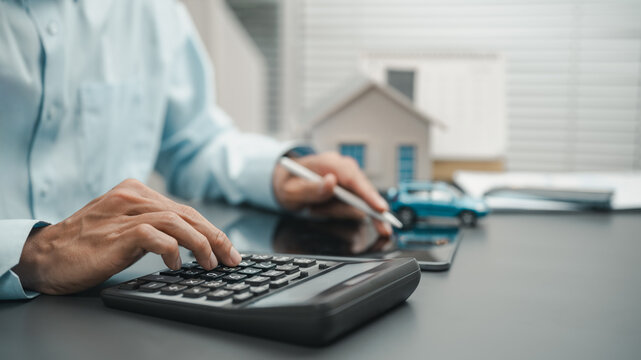 Financial planning for mortgage and loan calculations using a calculator with home and vehicle models. Represents budgeting, interest analysis, affordability assessment, and smart borrowing decisions.