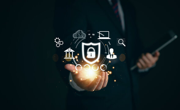 The businessman's finger touches the padlock icon. This symbolizes cybersecurity, cutting-edge digital crime prevention technology, and a system to protect personal data access.