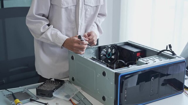 Asian man using screwdriver maintenance computer