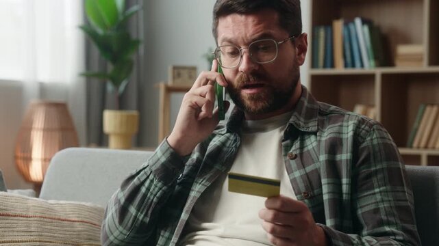 Angry Caucasian man shopping problem arguing call smartphone blocked credit card stressed irritated annoyed male guy online talking support help bank service talk argue conflict mobile phone at home