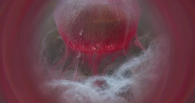 Ink powder. Pigment splash. White red shimmering blob on diamond sphere. Color dripping mix abstract defocused round frame background.