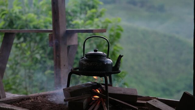 A kettle of boiling water on brazier in wooden house