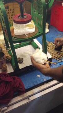 Street Vendor Shaping Shaved Ice Snowball On A Stick For Indian Ice Gola