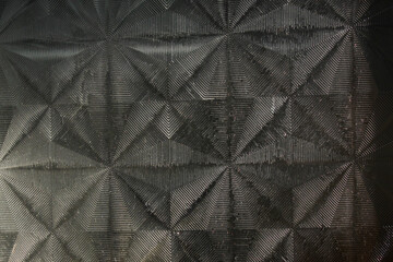 Obraz premium Black glass surface texture with intricate striped geometric pattern