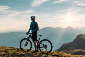 Fototapeta premium Mountain biker on summit ridge watching sunrise adventure cycling outdoor landscape