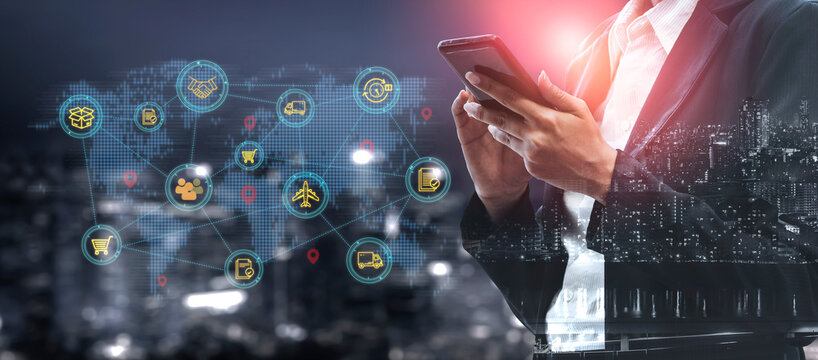 Businessman Using Smartphone with Global Network Icons and Digital Cityscape Background at Night Showing Modern Technology and Connectivity Trends. Entropy.