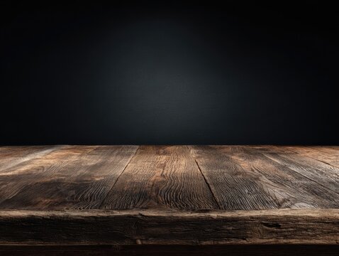 Rustic wooden table in soft focus against a blurred black backdrop