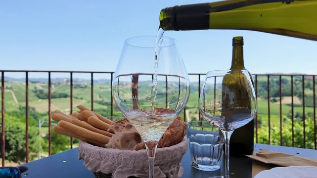 Slow Motion Pour of White Wine with Vineyard View in Piedmont Italy