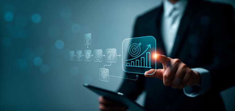 Business professional using tablet and touching virtual digital transformation workflow interface with growth chart target icon automation data analytics and connected process in modern office