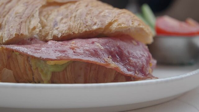Enjoying a ham croissant at a local cafe in Paris